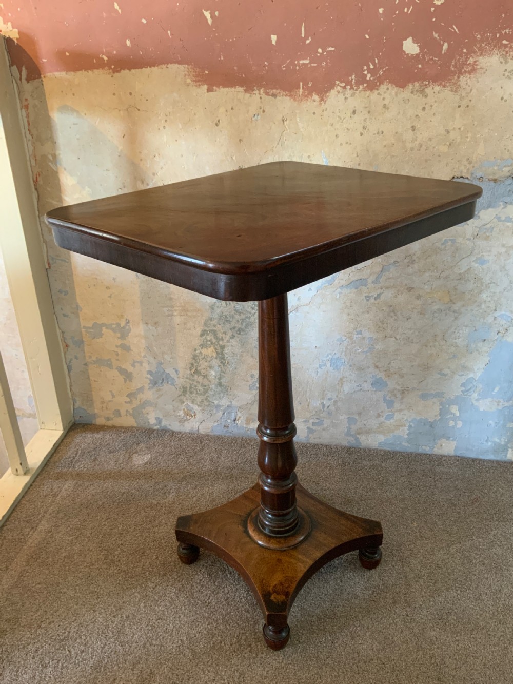 An early 19th century mahogany lamp table