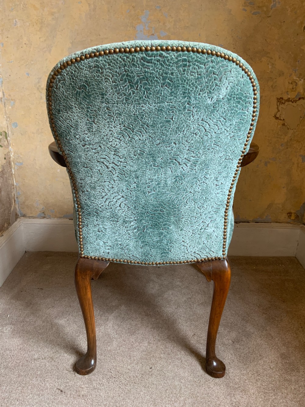 An antique walnut open armchair featuring light green textured upholstery, carved cabriole legs with ball and claw feet, and curved wooden armrests. View IV