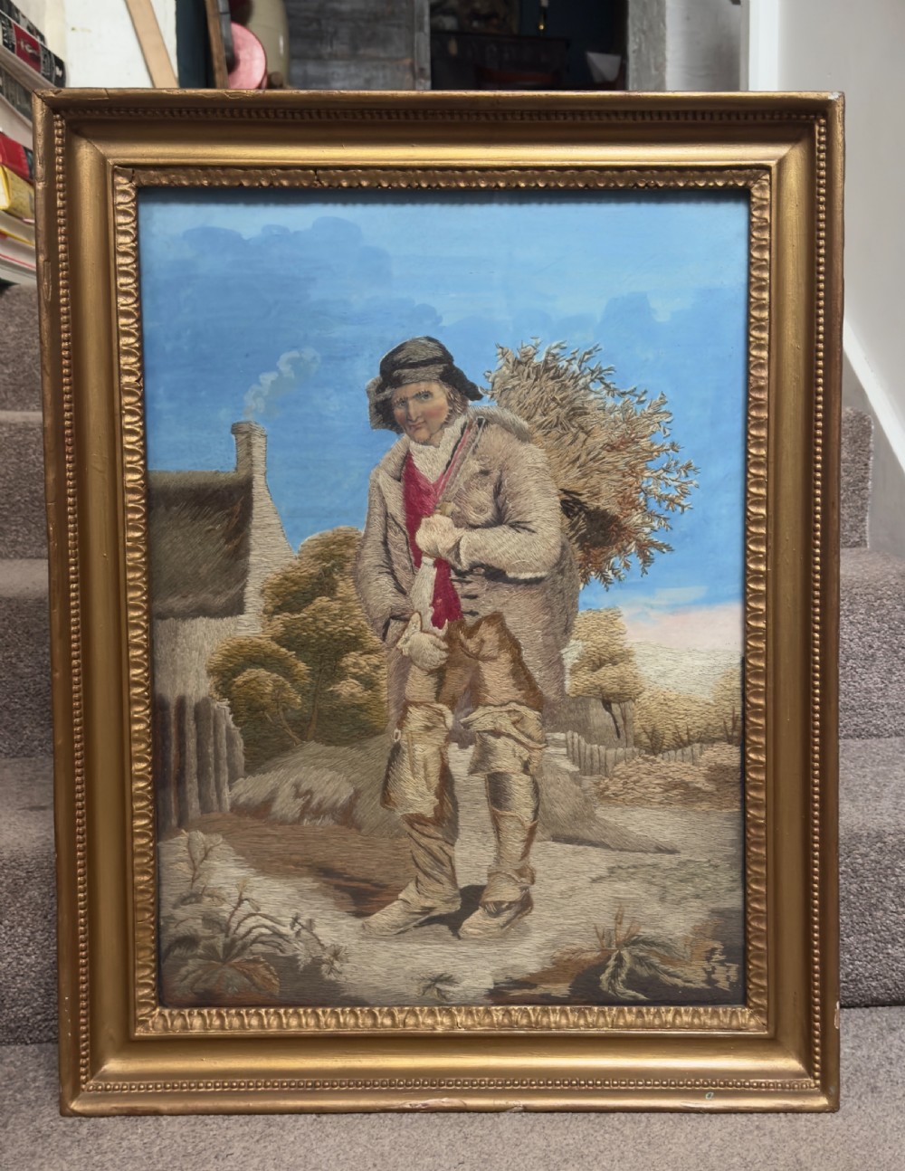 An antique late Regency long stitch silk embroidery depicting a country huntsman with his dog, framed in an ornate giltwood frame. View V