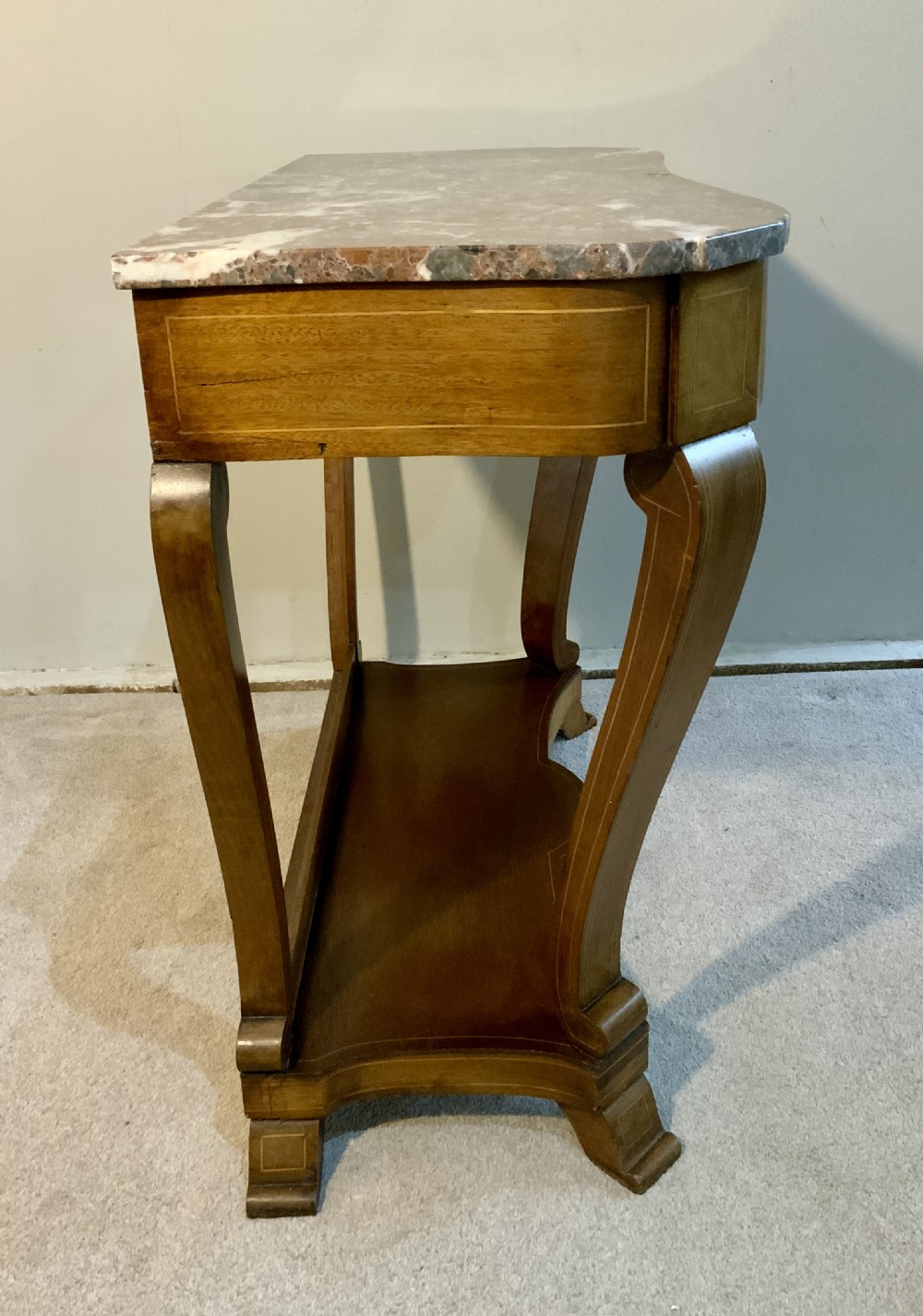 A mahogany console table featuring a shaped brown and grey marble top, floral marquetry frieze, curved cabriole legs, and a lower shelf. View II