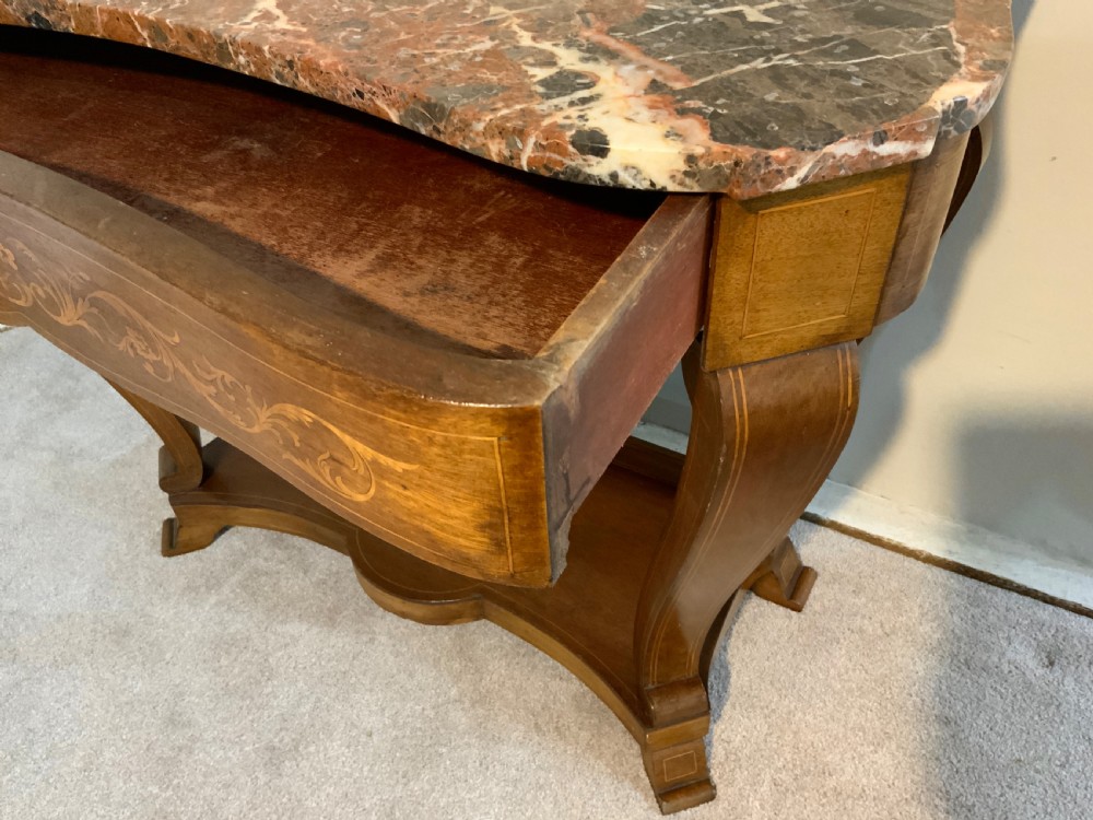 A mahogany console table featuring a shaped brown and grey marble top, floral marquetry frieze, curved cabriole legs, and a lower shelf. View V