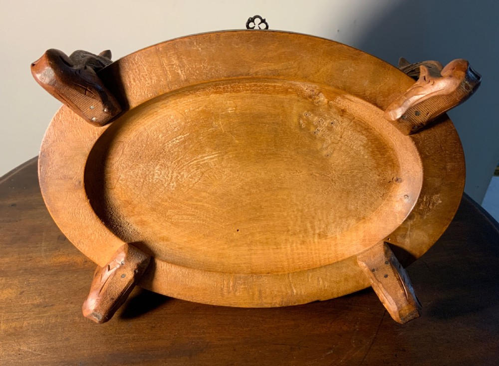 An antique carved wooden casket featuring a detailed top finial with two sculpted birds perched on foliage, sitting on carved feet with a keyhole in the front base. View VII