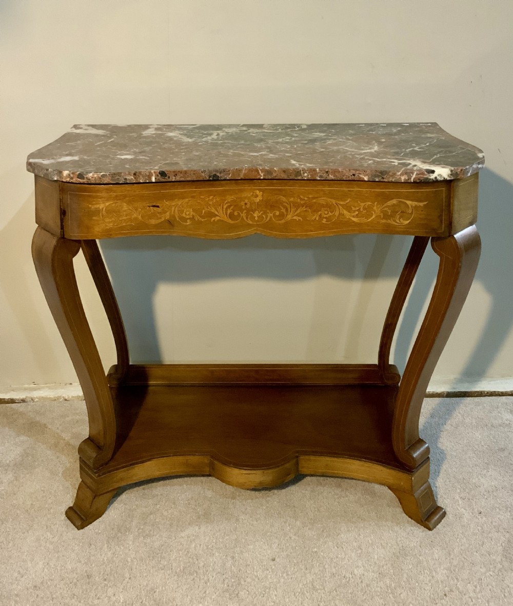 A mahogany console table featuring a shaped brown and grey marble top, floral marquetry frieze, curved cabriole legs, and a lower shelf.