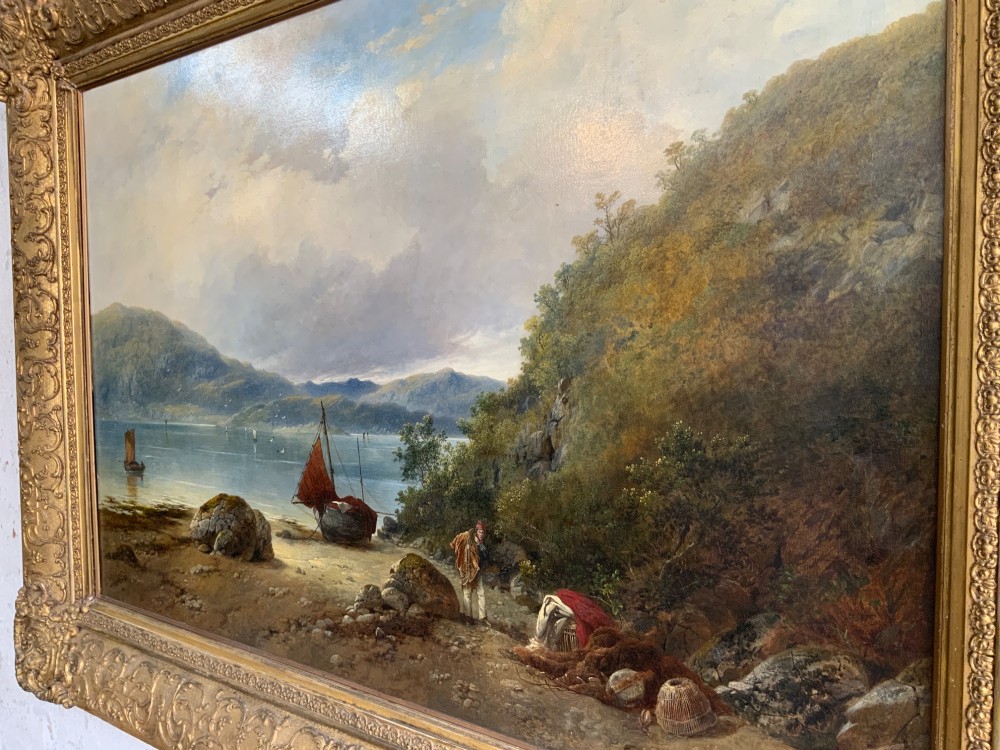A 19th-century oil painting on canvas showing a coastal shoreline with sailing vessels, framed in an ornate gilded gesso frame. View II