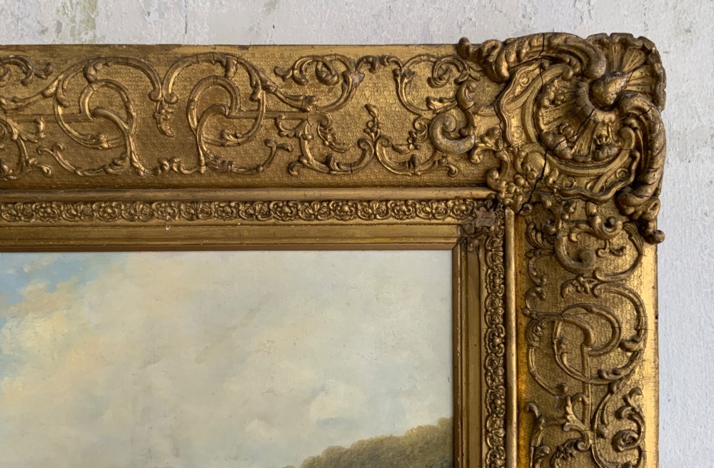 A 19th-century oil painting on canvas showing a coastal shoreline with sailing vessels, framed in an ornate gilded gesso frame. View III