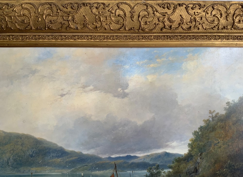 A 19th-century oil painting on canvas showing a coastal shoreline with sailing vessels, framed in an ornate gilded gesso frame. View VI