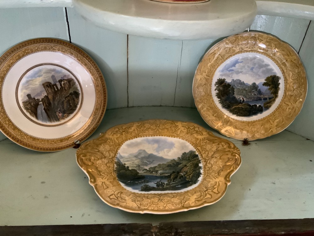 A twelve-piece collection of Victorian English Staffordshire Prattware ceramics including plates, mugs, and dishes with transfer-printed pictorial scenes and pink and gold borders. View III
