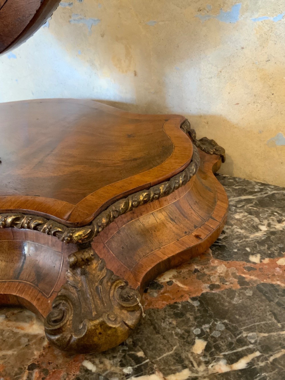 An oval walnut toilet mirror with an ormolu beaded border resting on a shaped serpentine base. View III