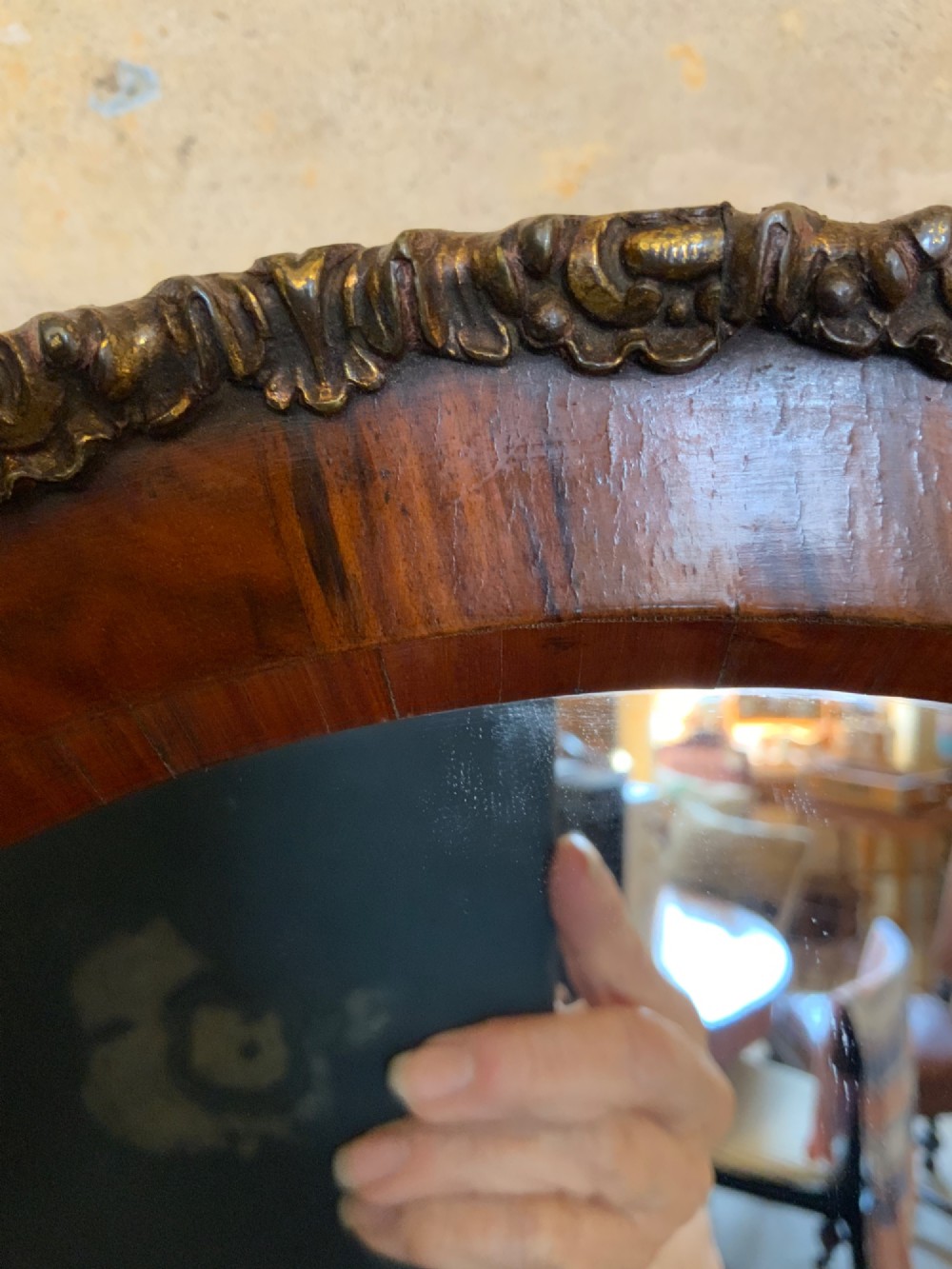 An oval walnut toilet mirror with an ormolu beaded border resting on a shaped serpentine base. View VII