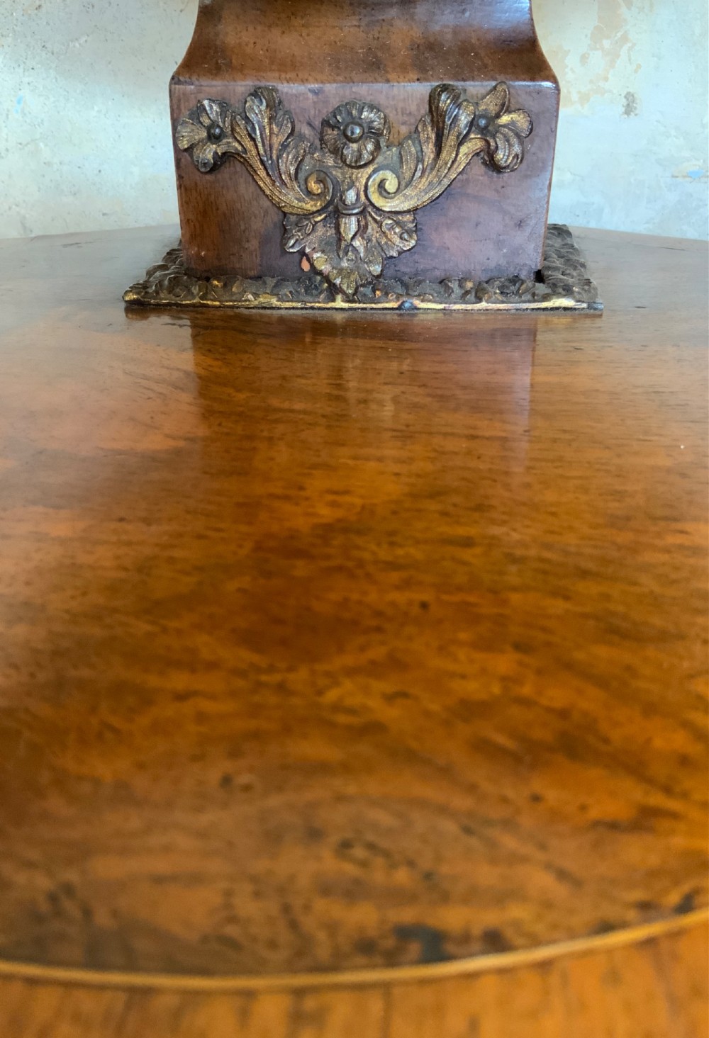 An oval walnut toilet mirror with an ormolu beaded border resting on a shaped serpentine base. View IX
