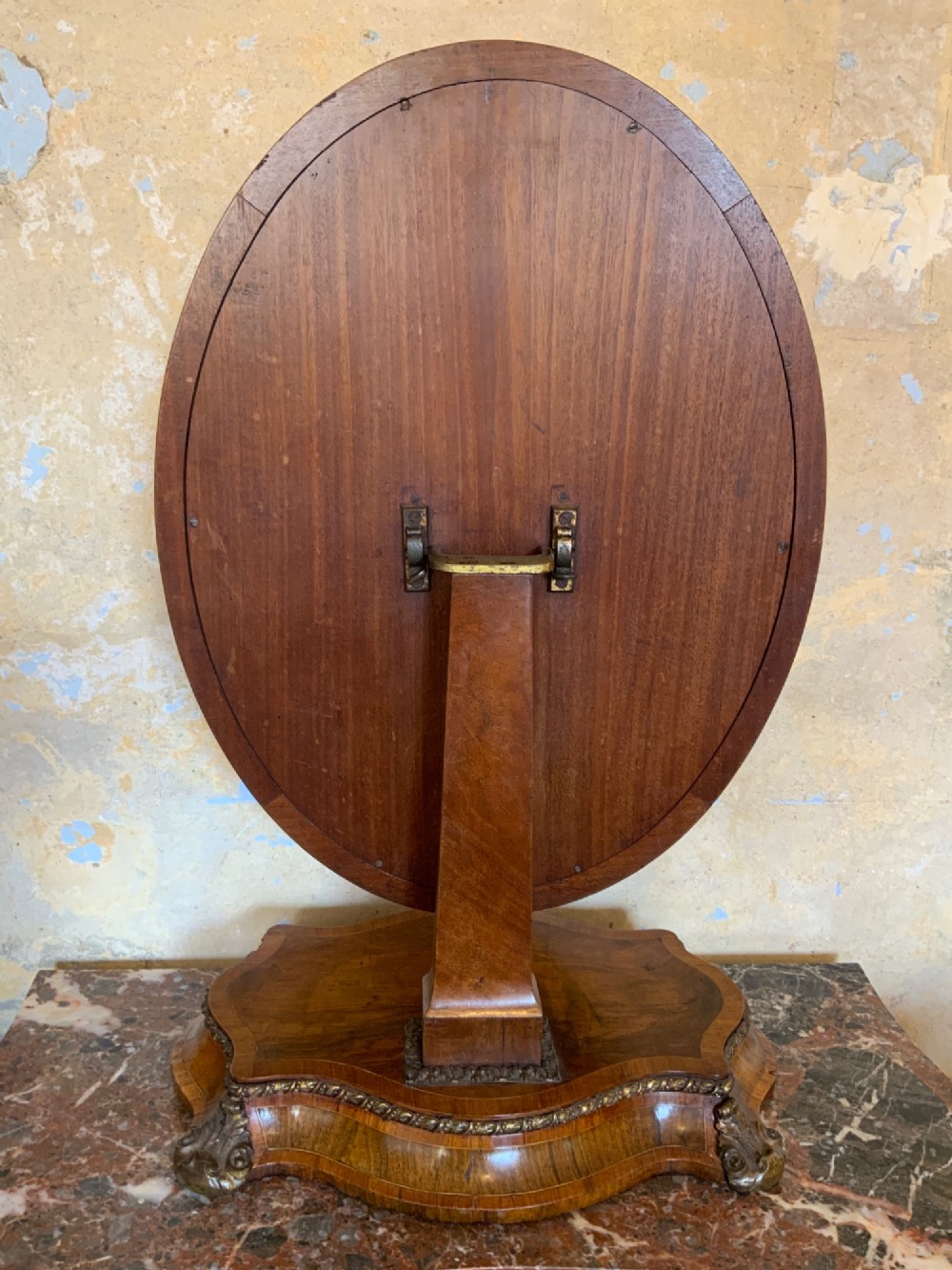 An oval walnut toilet mirror with an ormolu beaded border resting on a shaped serpentine base. View X