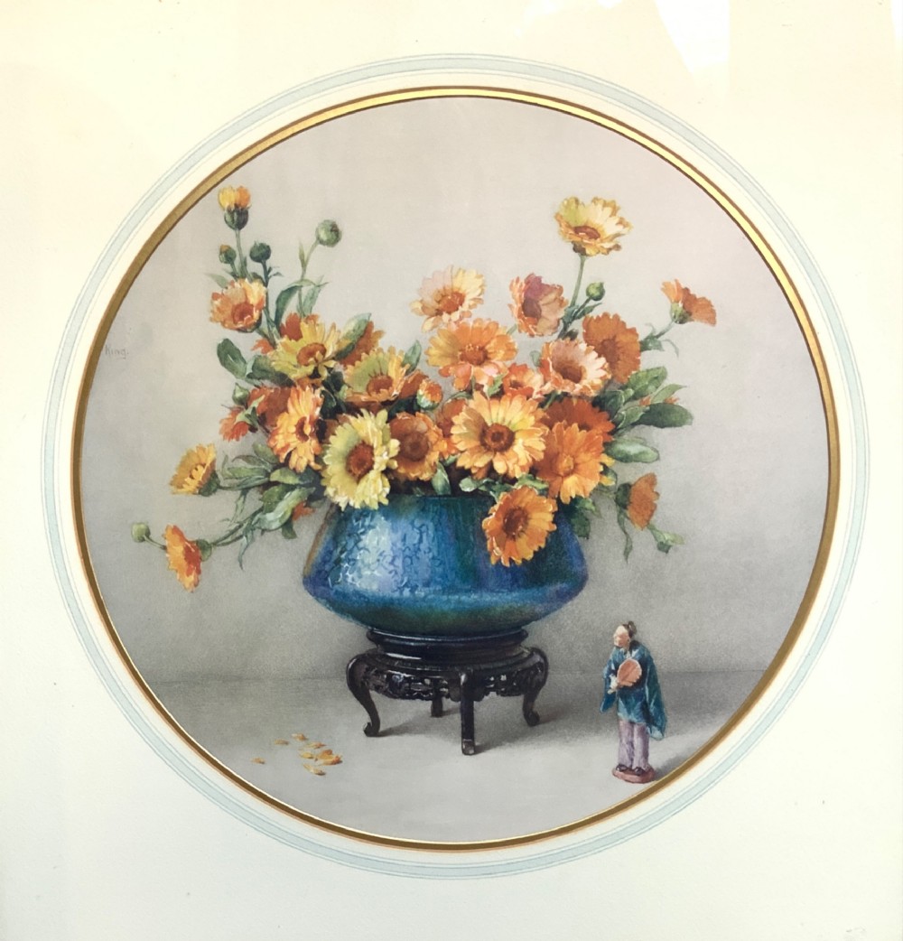 A square gilded framed watercolour painting displaying yellow and orange marigolds in a blue vessel alongside a small Chinese figurine. View II