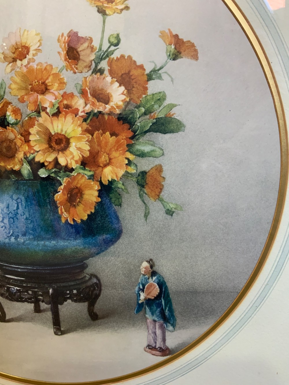 A square gilded framed watercolour painting displaying yellow and orange marigolds in a blue vessel alongside a small Chinese figurine. View III