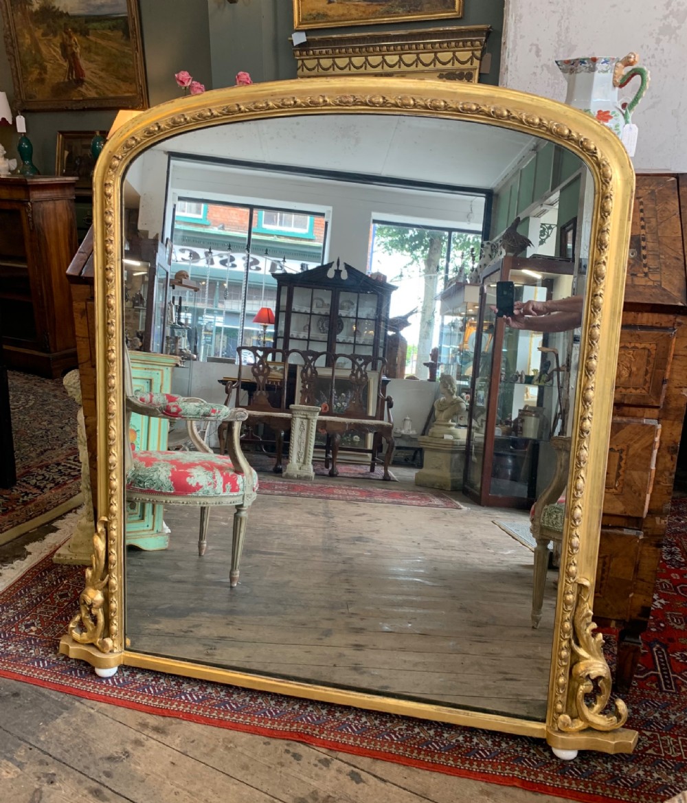 An early Victorian gilt framed over-mantle mirror