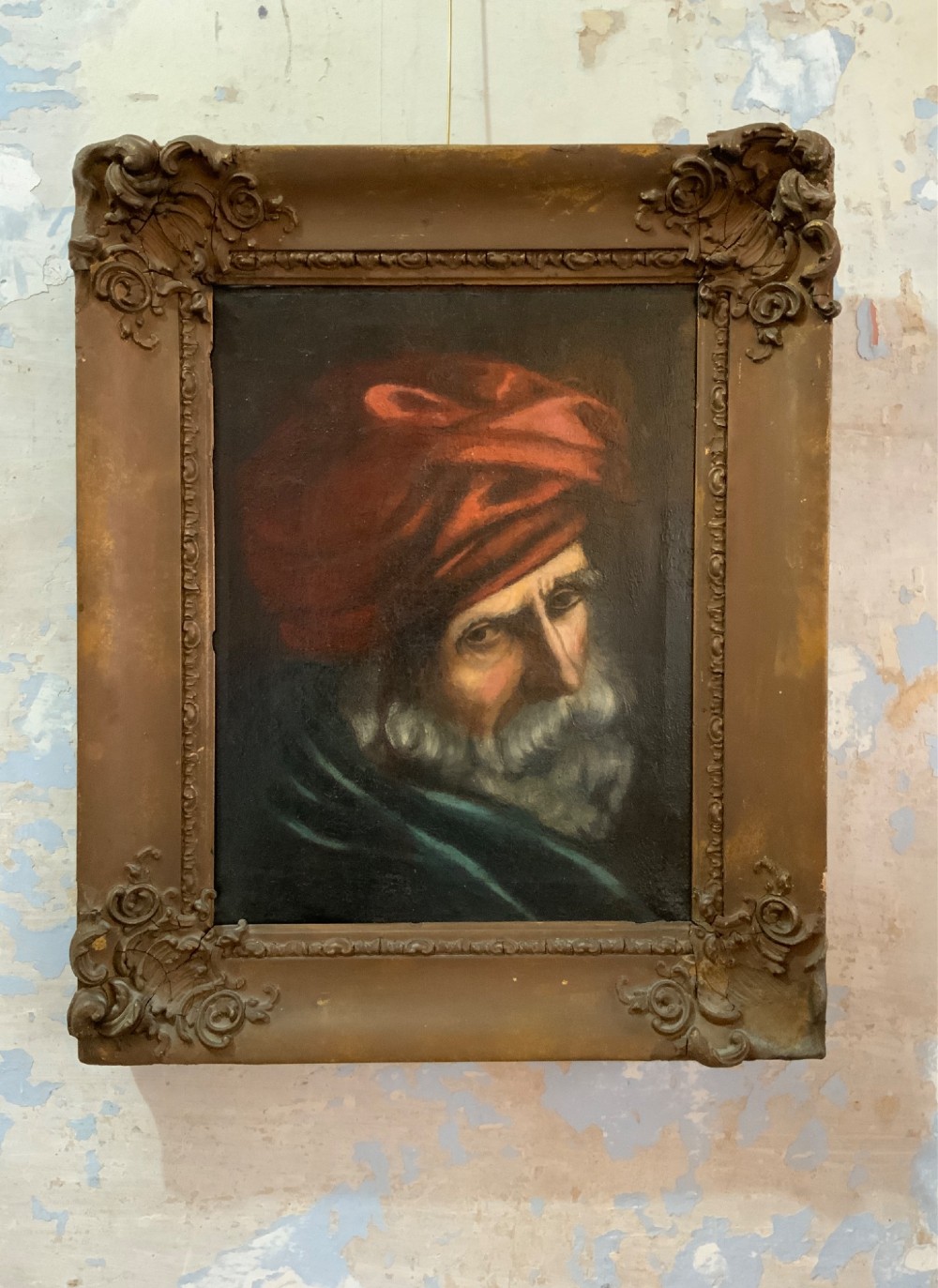 A 19th-century oil painting depicting a bearded gentleman in a red turban and dark robe, presented in an ornate rectangular giltwood frame.