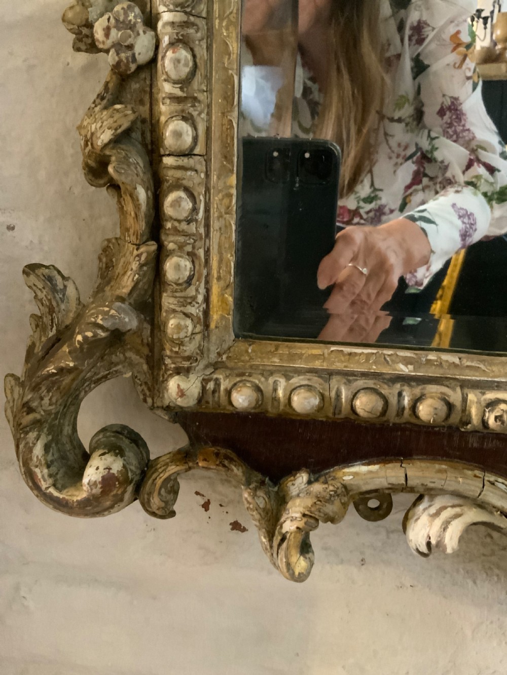 An 18th-century rectangular walnut wall mirror featuring elaborate parcel gilt carved cresting, bead moulding, and a decorative scrollwork apron. View III