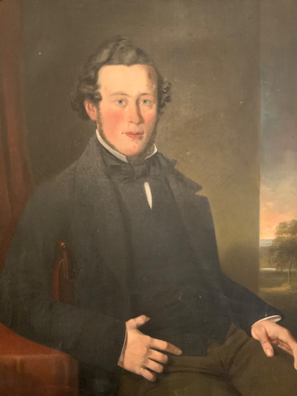 A 19th-century oil portrait of a gentleman in a dark suit seated within an ornate gilded frame. View II