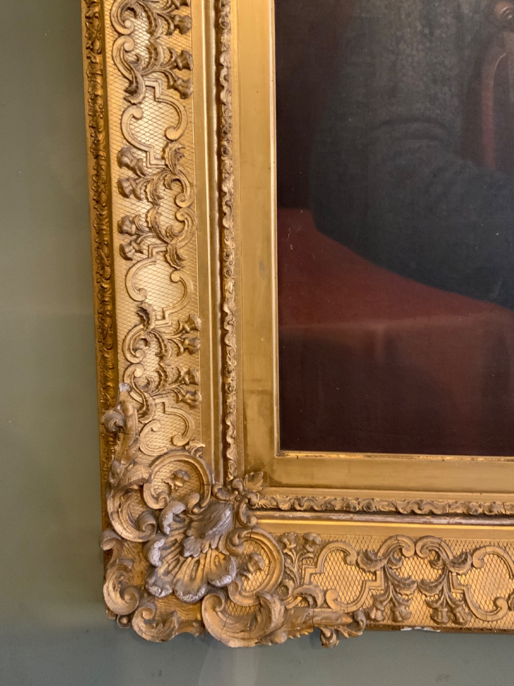 A 19th-century oil portrait of a gentleman in a dark suit seated within an ornate gilded frame. View III