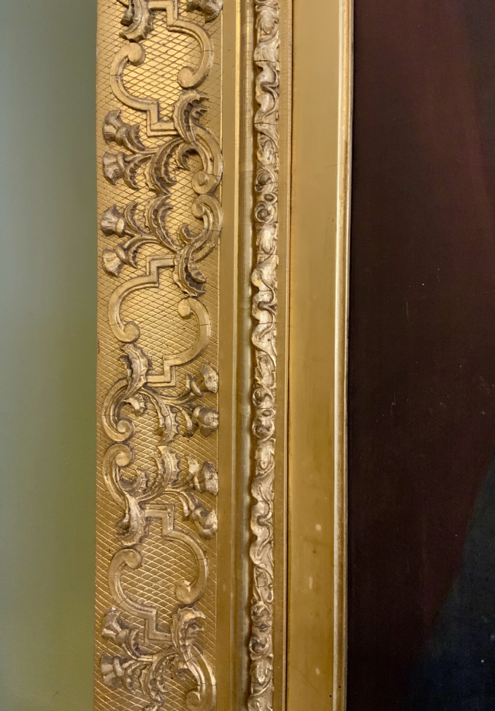 A 19th-century oil portrait of a gentleman in a dark suit seated within an ornate gilded frame. View VI