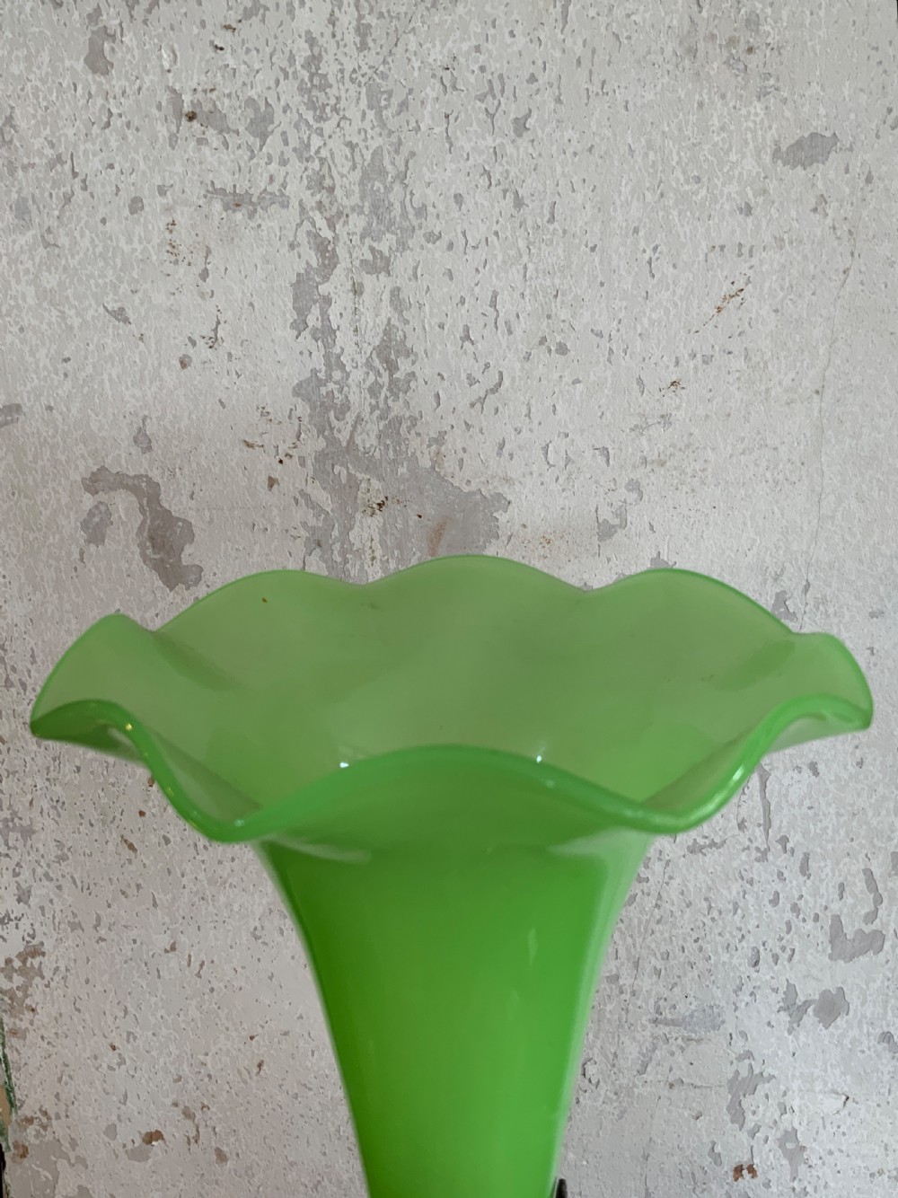An apple green trumpet-shaped glass vase mounted on a cast bronze base formed of sculpted leaf motifs. View V