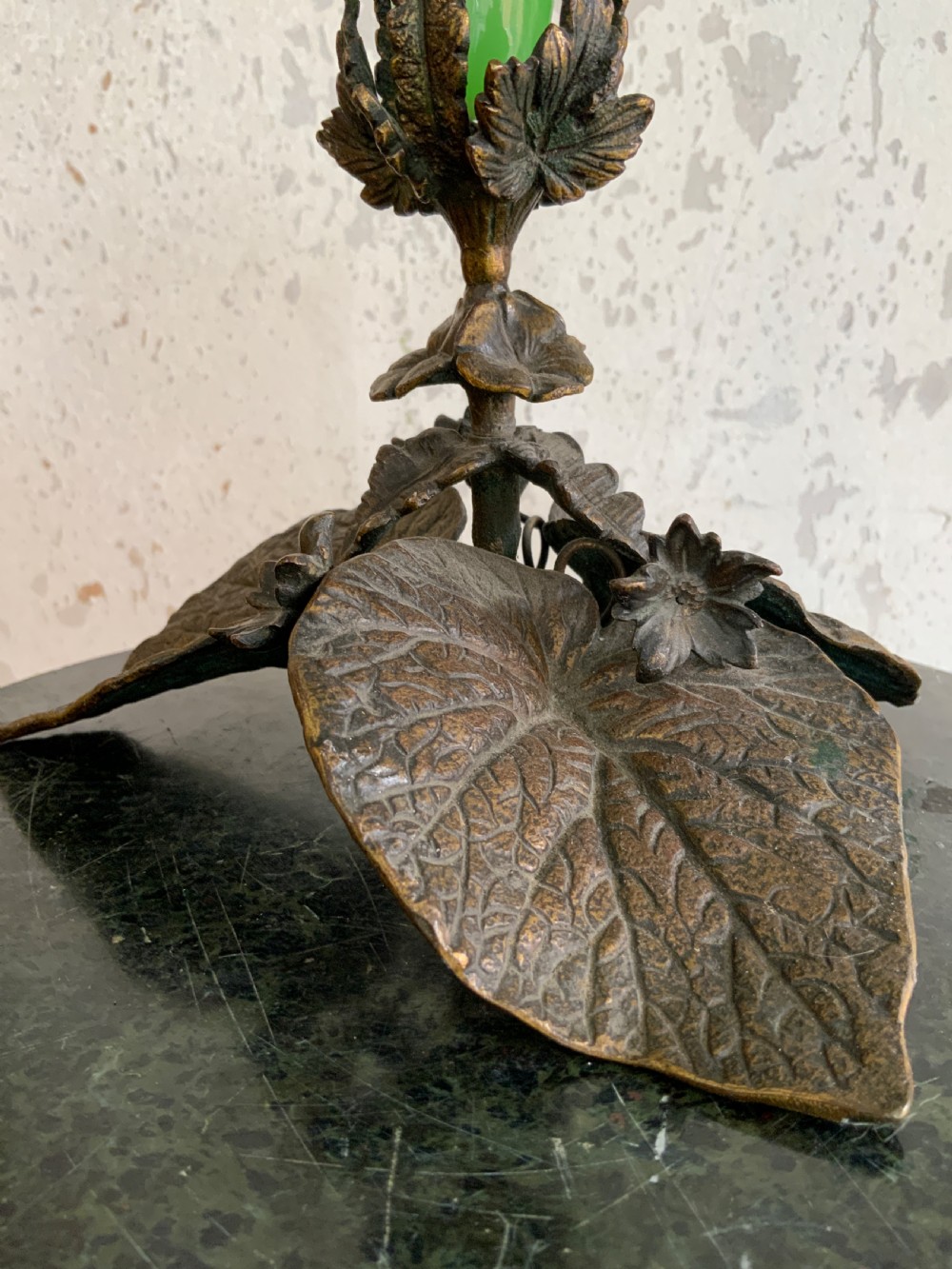 An apple green trumpet-shaped glass vase mounted on a cast bronze base formed of sculpted leaf motifs. View VI