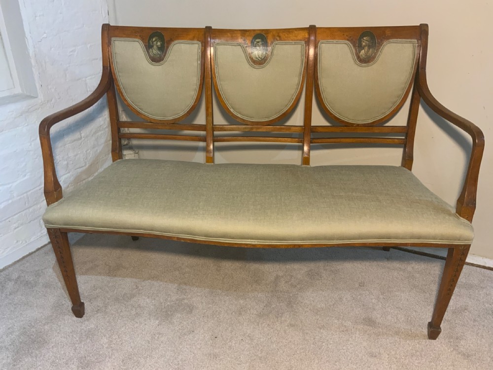 An early 19th-century Regency satinwood chair-back settee featuring three painted portrait medallions and light green fabric upholstery. View VIII