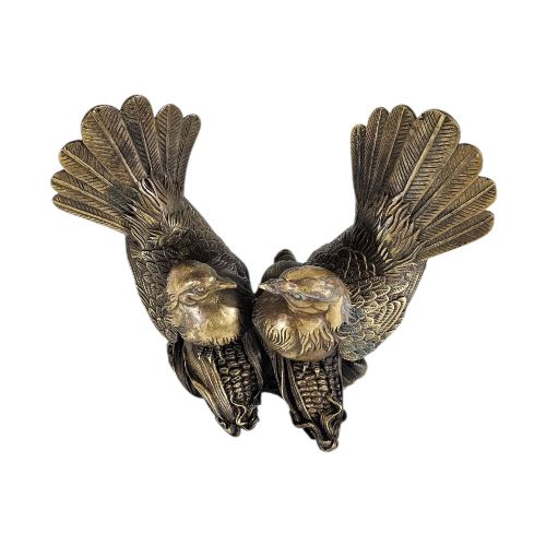 fig 2. A pair of cast bronze doves with detailed feather chasing and fanned tail feathers perched together on a maize cob base.