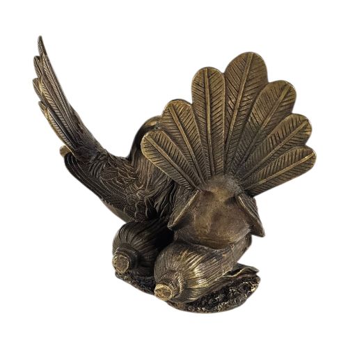 fig 6. A pair of cast bronze doves with detailed feather chasing and fanned tail feathers perched together on a maize cob base.