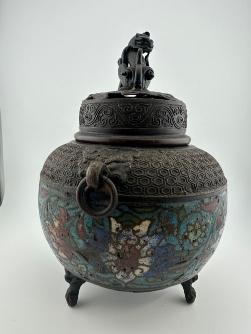 fig 2. A 19th-century Chinese bronze tripod censer featuring polychrome cloisonne enamel floral motifs, side loop handles, and a lid topped with a Qilin finial.