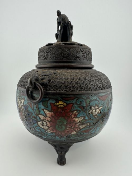 fig 4. A 19th-century Chinese bronze tripod censer featuring polychrome cloisonne enamel floral motifs, side loop handles, and a lid topped with a Qilin finial.