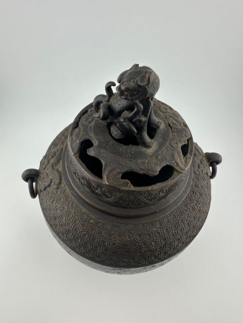 fig 6. A 19th-century Chinese bronze tripod censer featuring polychrome cloisonne enamel floral motifs, side loop handles, and a lid topped with a Qilin finial.