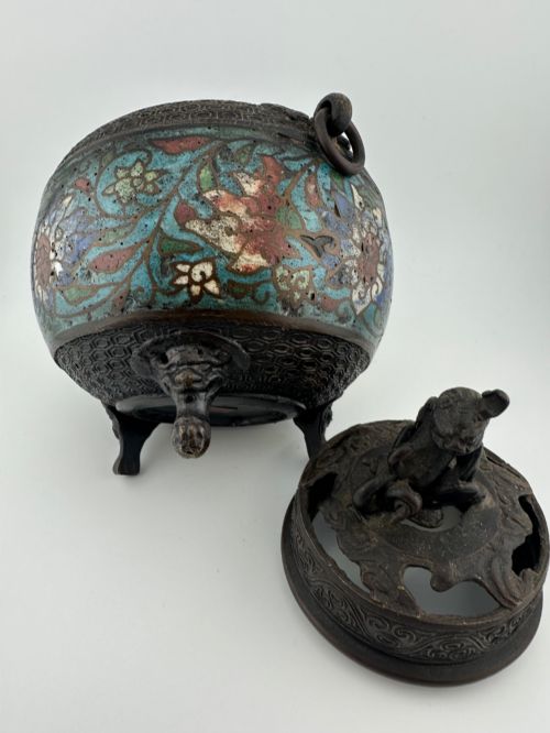 fig 7. A 19th-century Chinese bronze tripod censer featuring polychrome cloisonne enamel floral motifs, side loop handles, and a lid topped with a Qilin finial.