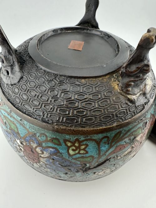 fig 10. A 19th-century Chinese bronze tripod censer featuring polychrome cloisonne enamel floral motifs, side loop handles, and a lid topped with a Qilin finial.