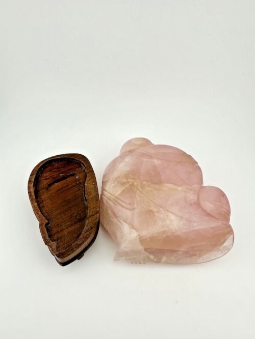 fig 5. A hand-carved pink rose quartz figure of a seated Laughing Buddha resting upon a custom dark wood stand.