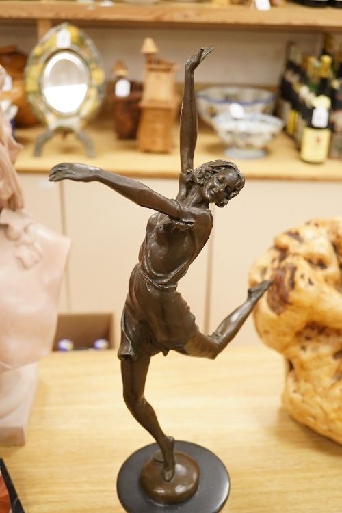 fig 2. An Art Deco style bronze sculpture of a female dancer in mid-leap mounted on a rounded variegated orange marble base.