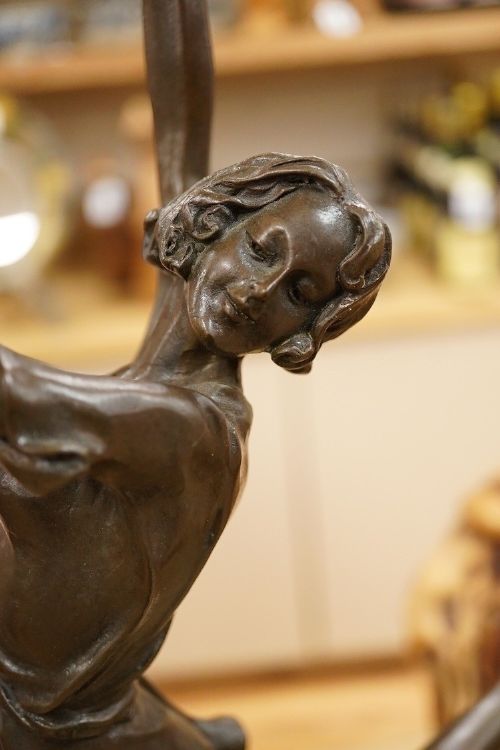 An Art Deco style bronze sculpture of a female dancer in mid-leap mounted on a rounded variegated orange marble base. View VIII