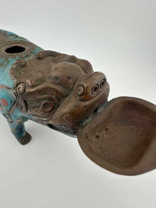 fig 8. An antique Chinese bronze censer shaped as a mythical beast decorated with turquoise cloisonne enamel and colourful scrollwork.