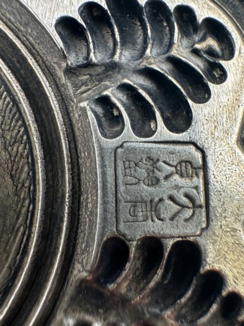 fig 2. A lobed Chinese white metal dish with raised relief repousse lotus foliage and a central floral motif.