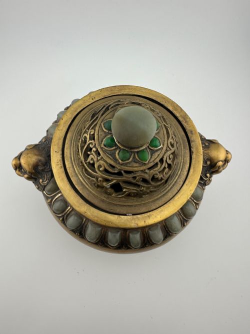 fig 2. An antique gilded bronze Chinese censer featuring hardstone and jade cabochon inlays, beast-head handles, a pierced cover, and a matching carved stand.