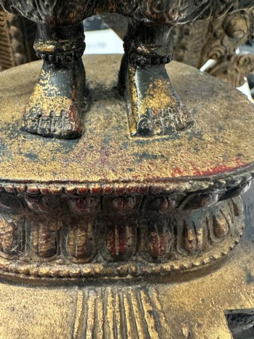 fig 9. A dark bronze Tibetan sculpture depicting eleven-headed Avalokiteshvara with radiating arms set against a halo mandorla on a lotus pedestal.