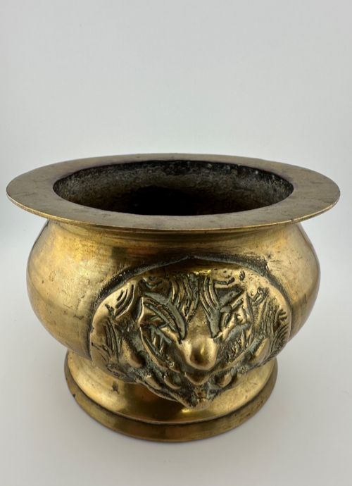 fig 3. A rounded antique brass Chinese censer featuring a flared rim, pedestal base, and sculpted lion mask handles on either side.