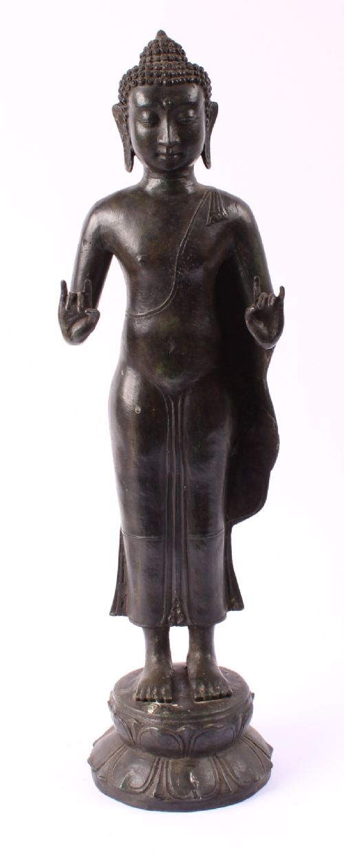 fig 1. A 19th-century Thai Rattanakosin bronze standing Buddha figure depicted in double mudra posture mounted on a tiered lotus pedestal.