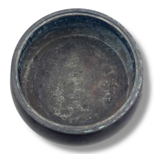 fig 4. A dark patinated bronze tripod censer featuring a rounded body, three short tapered feet, and a pierced openwork lid topped with a bud finial.