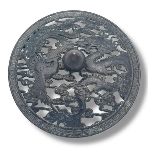 fig 6. A dark patinated bronze tripod censer featuring a rounded body, three short tapered feet, and a pierced openwork lid topped with a bud finial.