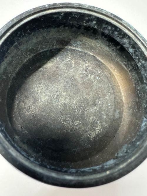 fig 8. A dark patinated bronze tripod censer featuring a rounded body, three short tapered feet, and a pierced openwork lid topped with a bud finial.