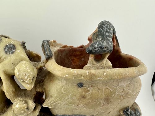 fig 3. An antique Chinese carved soapstone double brush washer featuring two vessel shapes supported by carved animals and pierced rockwork in shades of mottled green, cream, and dark grey.