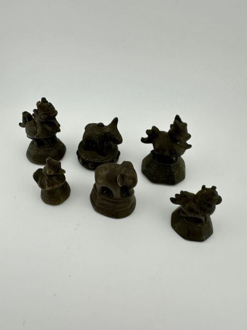 fig 1. A set of six dark bronze zoomorphic trade weights depicting various animals mounted on octagonal and circular pedestals.