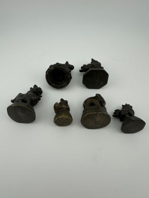 fig 2. A set of six dark bronze zoomorphic trade weights depicting various animals mounted on octagonal and circular pedestals.