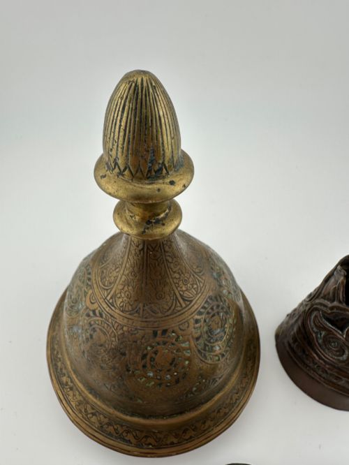 fig 2. A five-piece group of antique Persian Qajar metalware, including an engraved brass incense burner lid with a finial, a dark carved vessel collar, and three small circular lids.