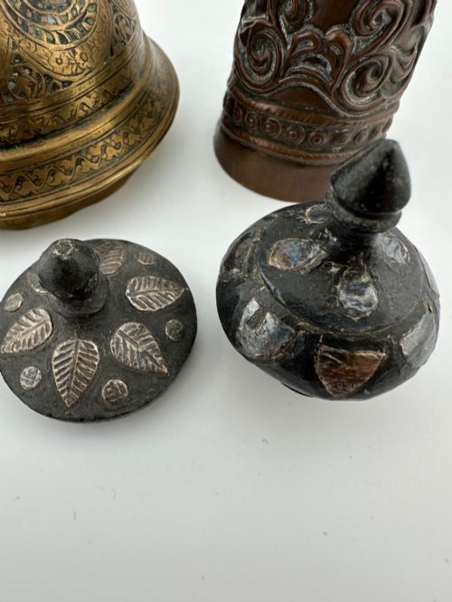 fig 5. A five-piece group of antique Persian Qajar metalware, including an engraved brass incense burner lid with a finial, a dark carved vessel collar, and three small circular lids.